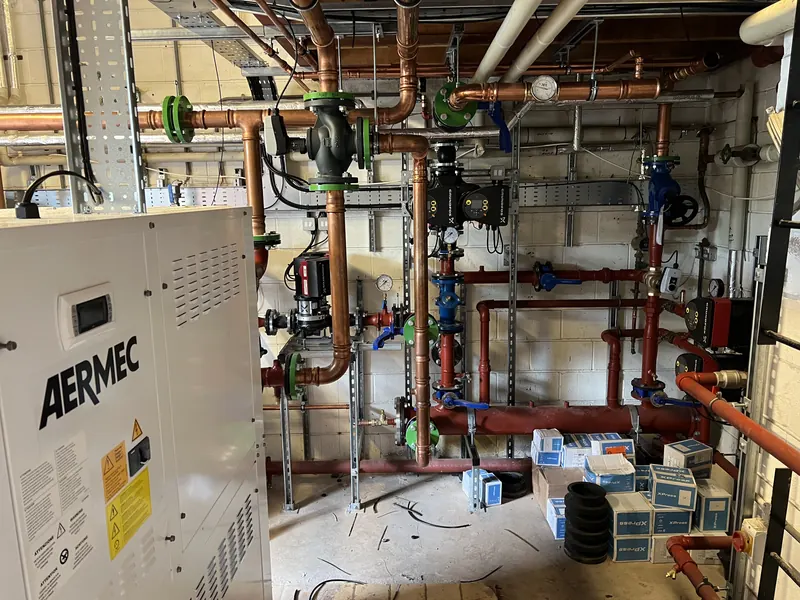 Plant room with packaged unit, pumps and copper pipework
