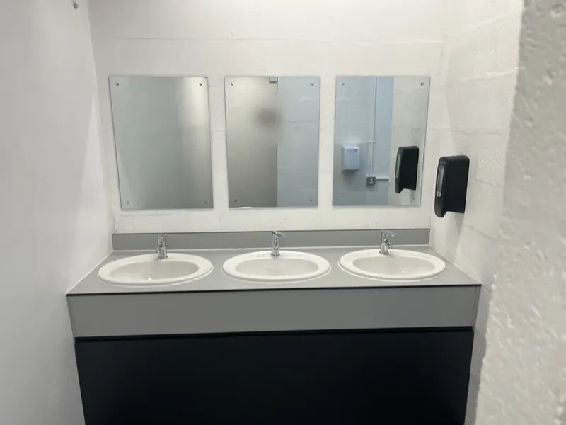 Washroom after: inset basins on a grey worktop with new mirrors